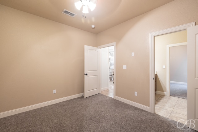 carpeted spare room featuring ceiling fan