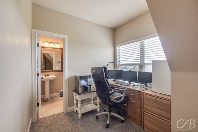 carpeted home office featuring sink