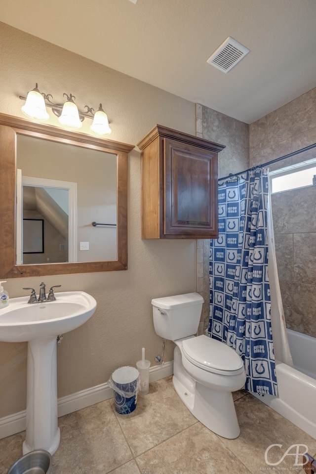 full bathroom featuring toilet, shower / bath combination with curtain, tile patterned floors, and sink