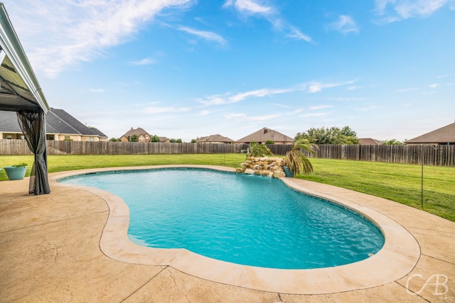 view of pool featuring a patio area, pool water feature, and a lawn