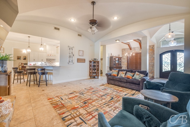 living room featuring french doors, vaulted ceiling, light tile patterned flooring, and ceiling fan