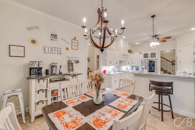 tiled dining room with crown molding and ceiling fan with notable chandelier