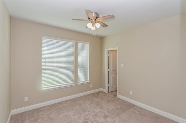 carpeted spare room with ceiling fan and a healthy amount of sunlight