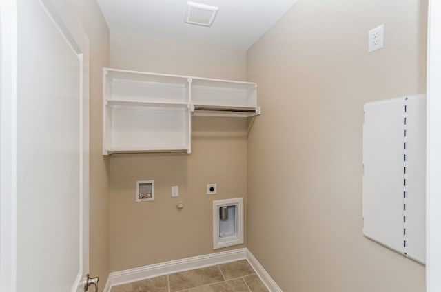 laundry area featuring hookup for a gas dryer, hookup for an electric dryer, washer hookup, and light tile patterned floors