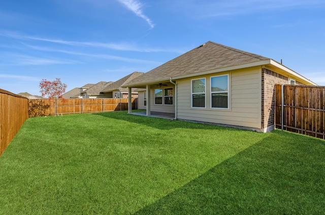 rear view of house featuring a patio and a lawn