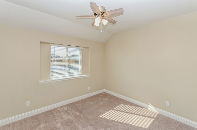 carpeted empty room featuring lofted ceiling and ceiling fan