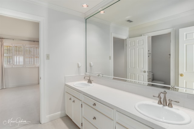 bathroom featuring ornamental molding, toilet, and vanity