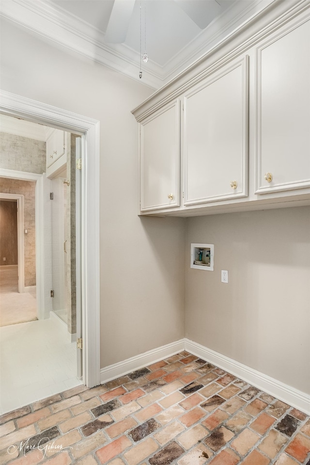 laundry room with washer hookup, crown molding, and cabinets