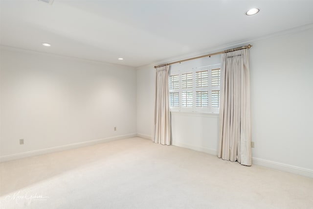 unfurnished room with light carpet, ornamental molding, recessed lighting, and baseboards