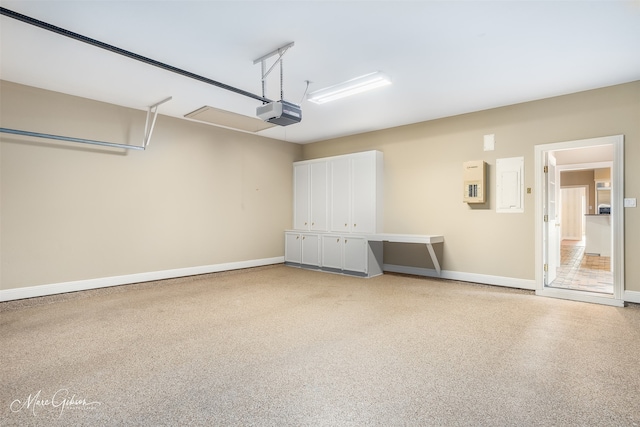 garage with baseboards and a garage door opener