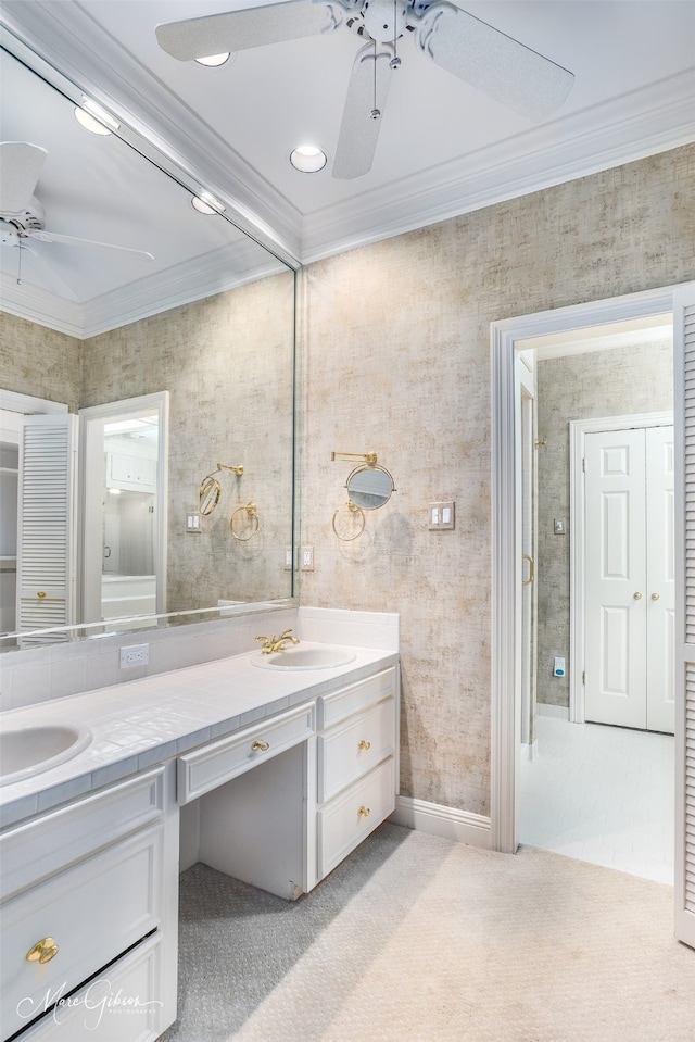 bathroom featuring a sink, double vanity, ornamental molding, and a ceiling fan