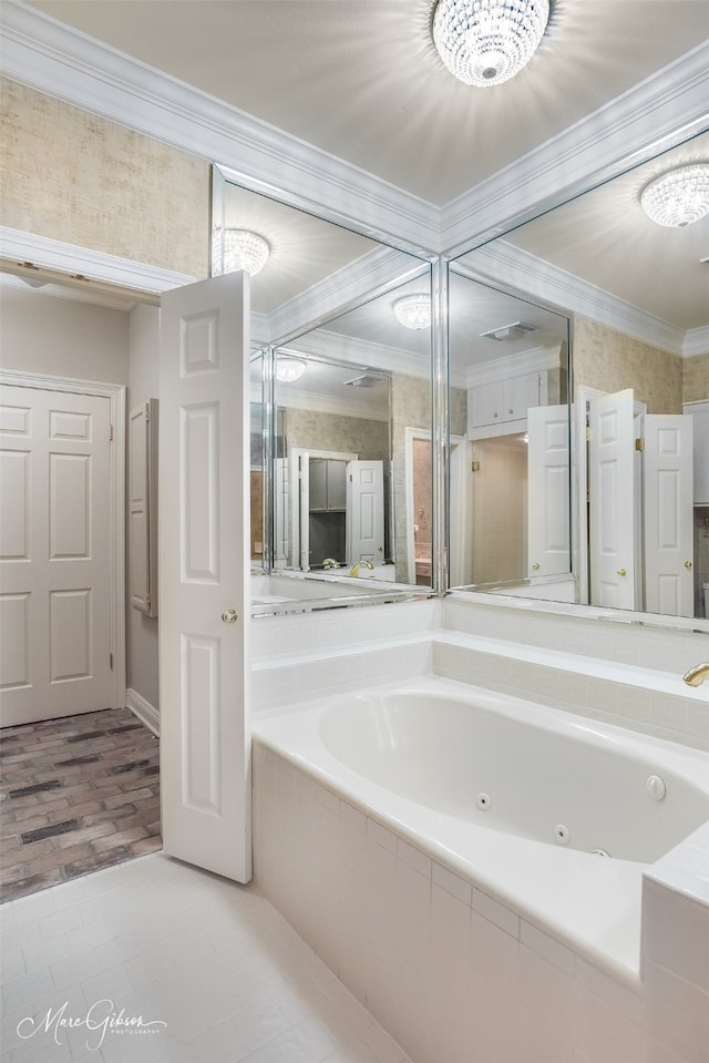 bathroom with ornamental molding and a jetted tub