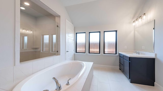 full bath with vanity, baseboards, vaulted ceiling, tiled shower, and a bath