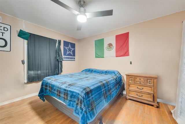 bedroom with ceiling fan and hardwood / wood-style floors