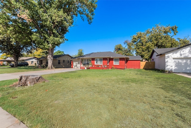 ranch-style home with a front lawn and a garage