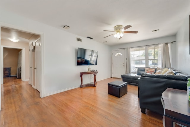 living room with hardwood / wood-style floors and ceiling fan