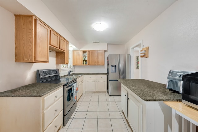 kitchen featuring stainless steel refrigerator with ice dispenser, light tile patterned flooring, electric range, and sink