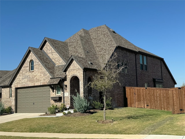 view of front facade featuring a garage and a front lawn