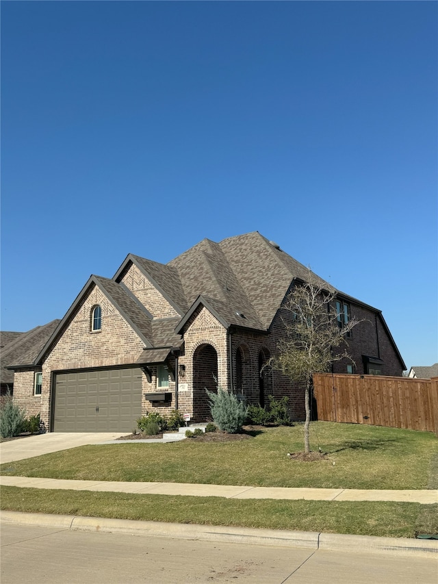 view of front of home with a front yard and a garage