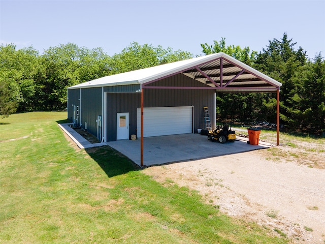 garage with a carport and a lawn