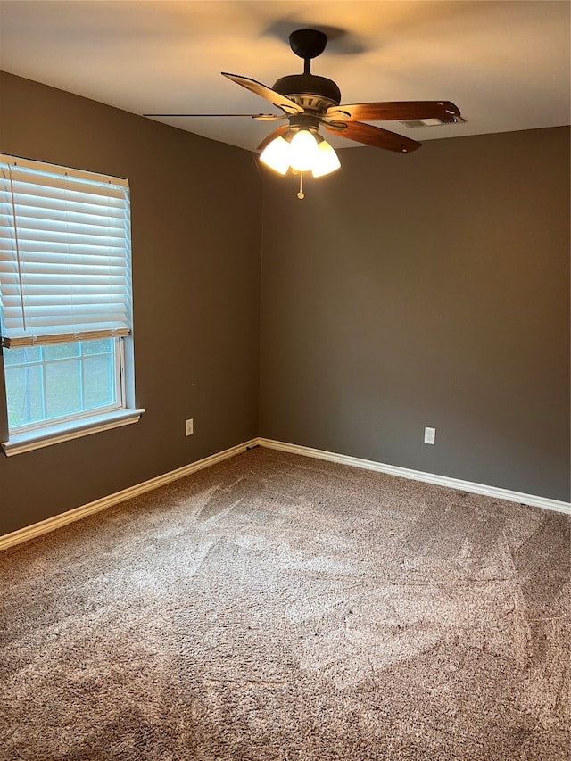 empty room with ceiling fan and carpet floors