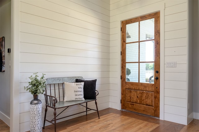 entryway with wooden walls and wood-type flooring