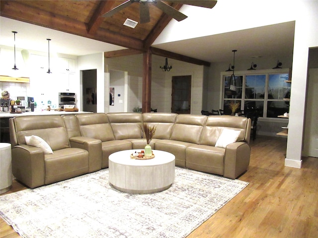 living room with light hardwood / wood-style floors, wood ceiling, beamed ceiling, high vaulted ceiling, and ceiling fan