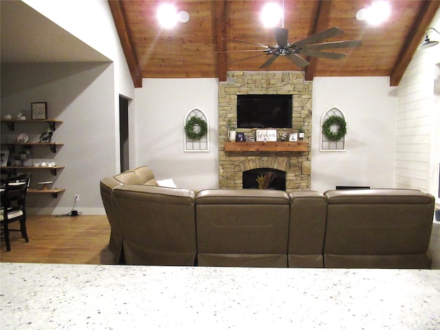 living room with vaulted ceiling, wood ceiling, hardwood / wood-style flooring, and a fireplace