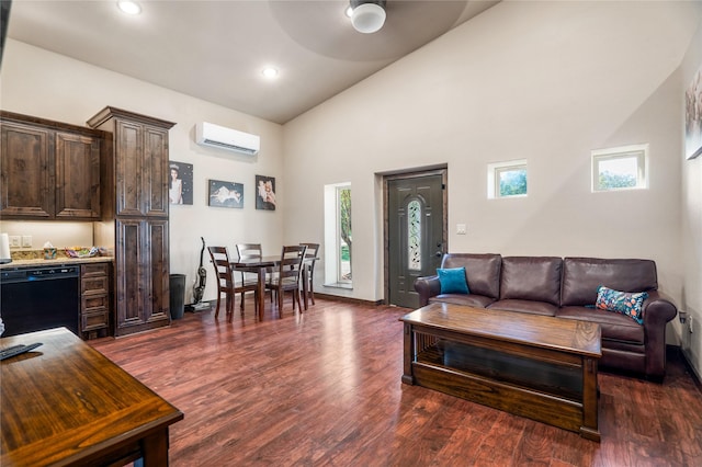 living room featuring dark hardwood / wood-style flooring, a wall mounted AC, and high vaulted ceiling