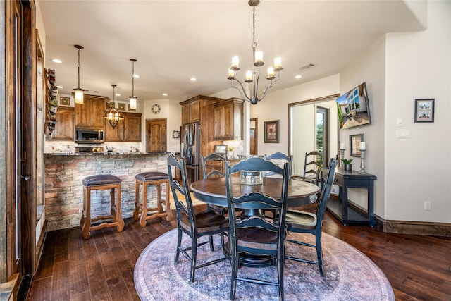 dining space with an inviting chandelier and dark hardwood / wood-style floors