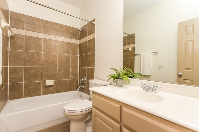 full bathroom featuring vanity, toilet, tile patterned floors, and tiled shower / bath combo