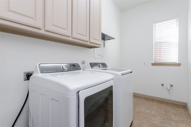 clothes washing area featuring washer and dryer and light tile patterned floors