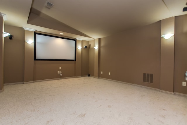 cinema featuring vaulted ceiling and light colored carpet