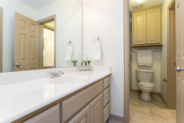 bathroom with vanity, toilet, and tile patterned flooring