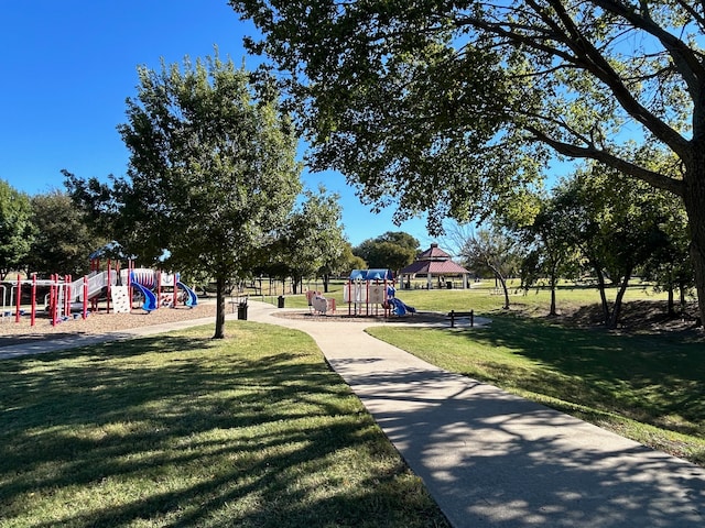 surrounding community featuring a playground and a yard