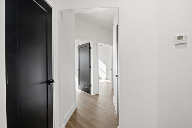 hall with light hardwood / wood-style floors