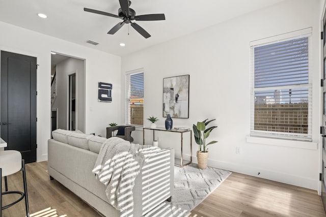 living room with hardwood / wood-style flooring and ceiling fan