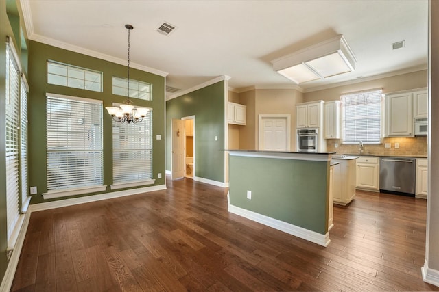 kitchen featuring pendant lighting, white cabinetry, appliances with stainless steel finishes, and a center island