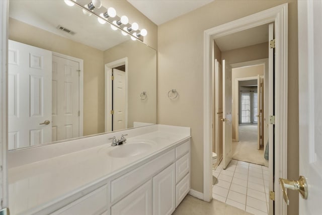 bathroom with tile patterned floors, vanity, and toilet