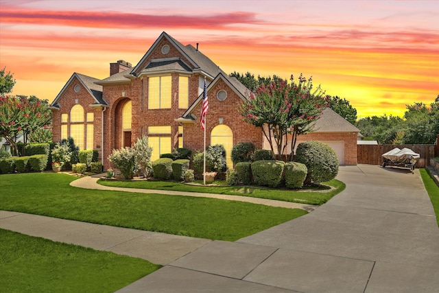 view of front of home with a lawn and a garage