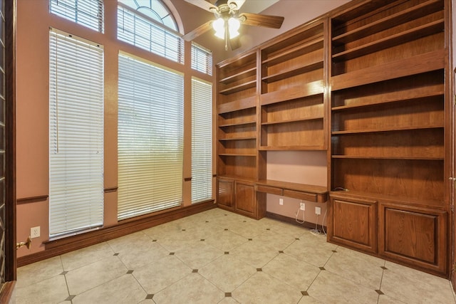 interior space with ceiling fan and built in desk