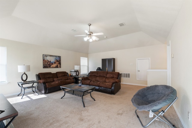 carpeted living room featuring vaulted ceiling, a wealth of natural light, and ceiling fan