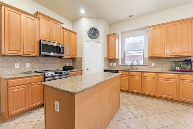 kitchen featuring a kitchen island, appliances with stainless steel finishes, pendant lighting, and backsplash