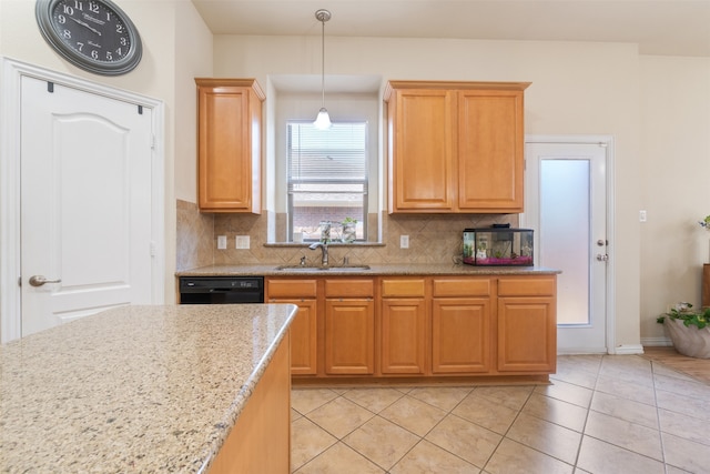 kitchen featuring black dishwasher, backsplash, light tile patterned flooring, sink, and decorative light fixtures