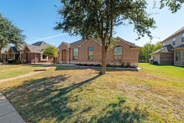 ranch-style home with a front yard and central AC