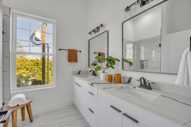 bathroom featuring vanity, an enclosed shower, and plenty of natural light