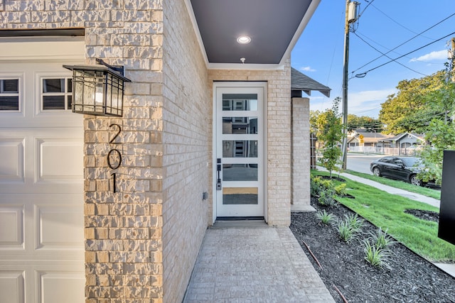 view of exterior entry with a garage