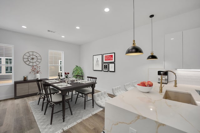 dining room featuring hardwood / wood-style floors and sink