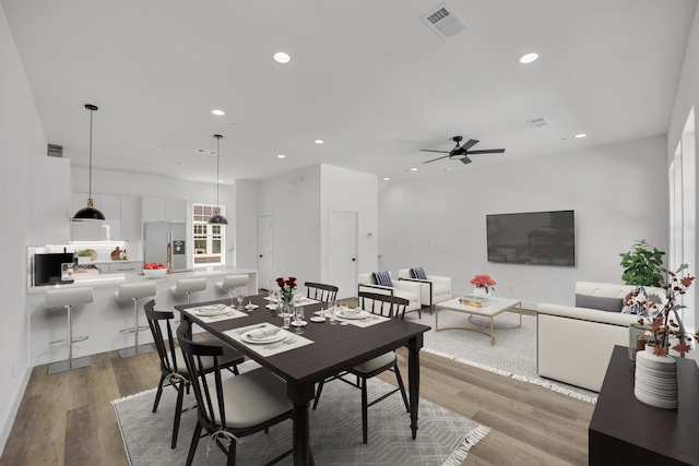 dining area with hardwood / wood-style flooring and ceiling fan