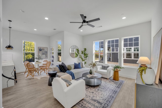 living room featuring ceiling fan and light wood-type flooring